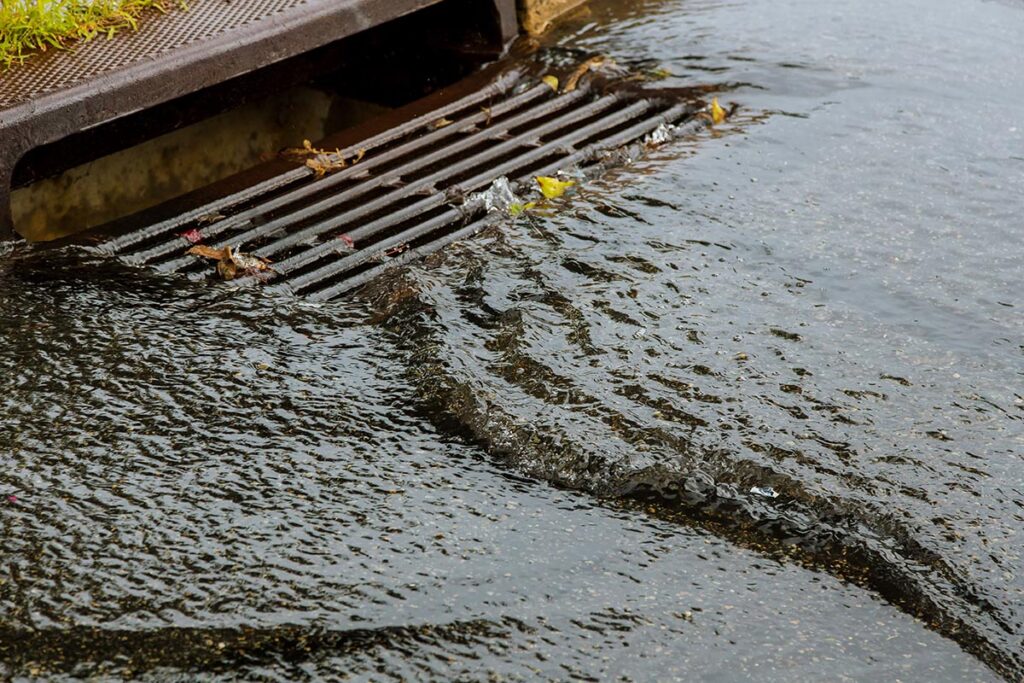 Water gushing from storm sewer following very heavy rainfall