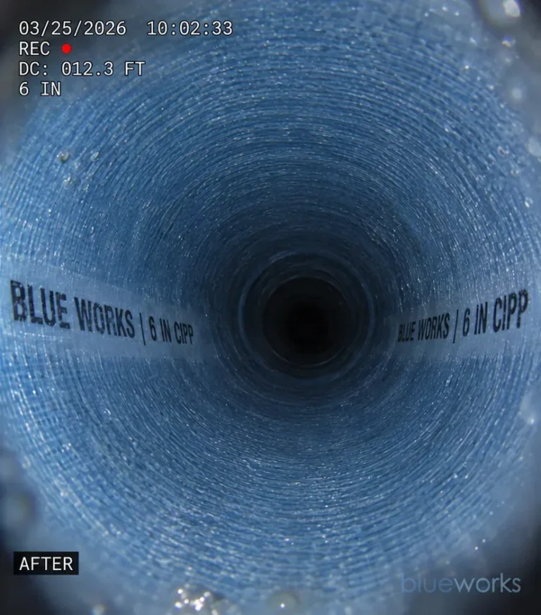 A continuous cured liner inside a restored cast iron sewer